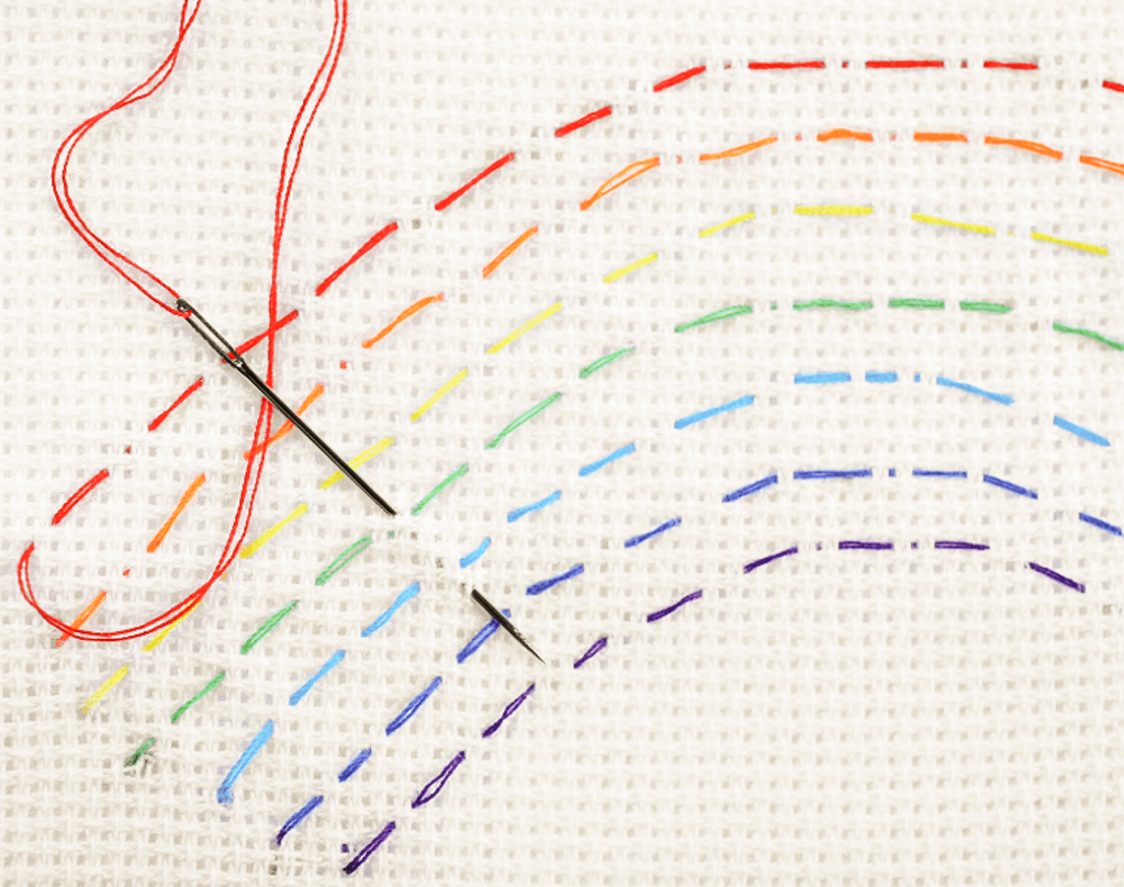 rainbow colored thread stitched in a rainbow shape